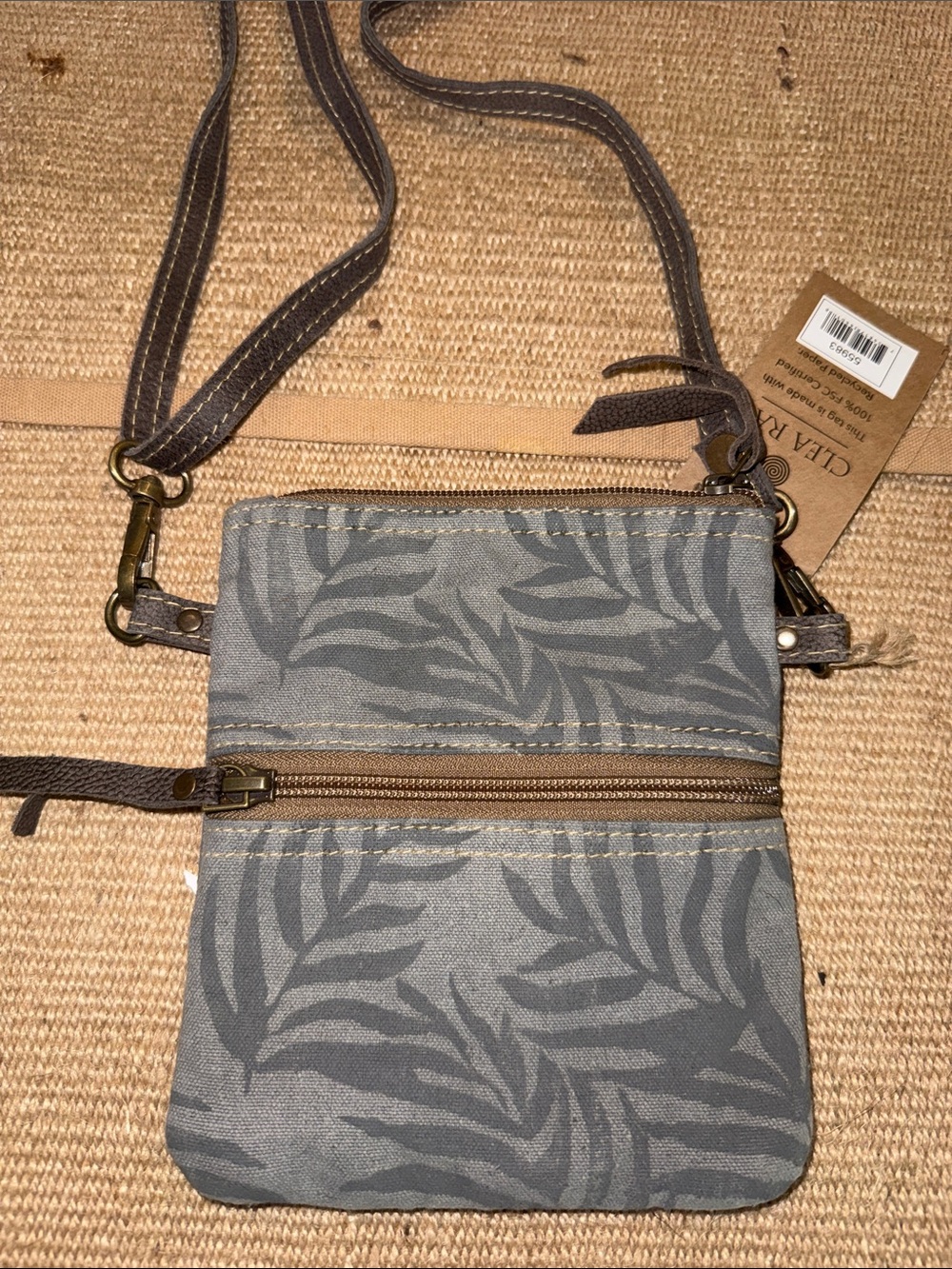 Clea Ray SKU: 55983
Leaf Front Passport Bag CROSSBODY made of upcycled canvas